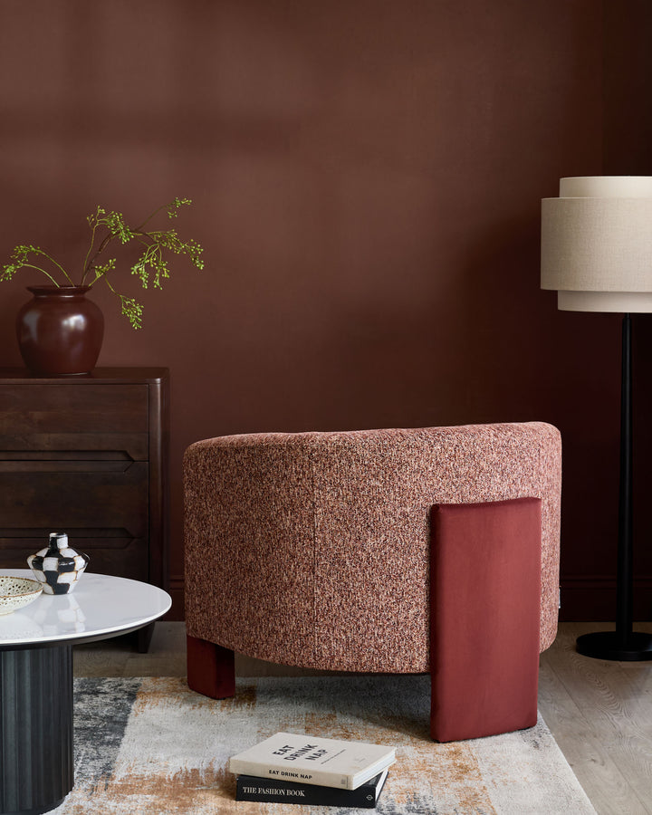 Miles occasional chair in toffee fabric with red velvet side panel, curved rounded form, displayed in styled living room setting.
