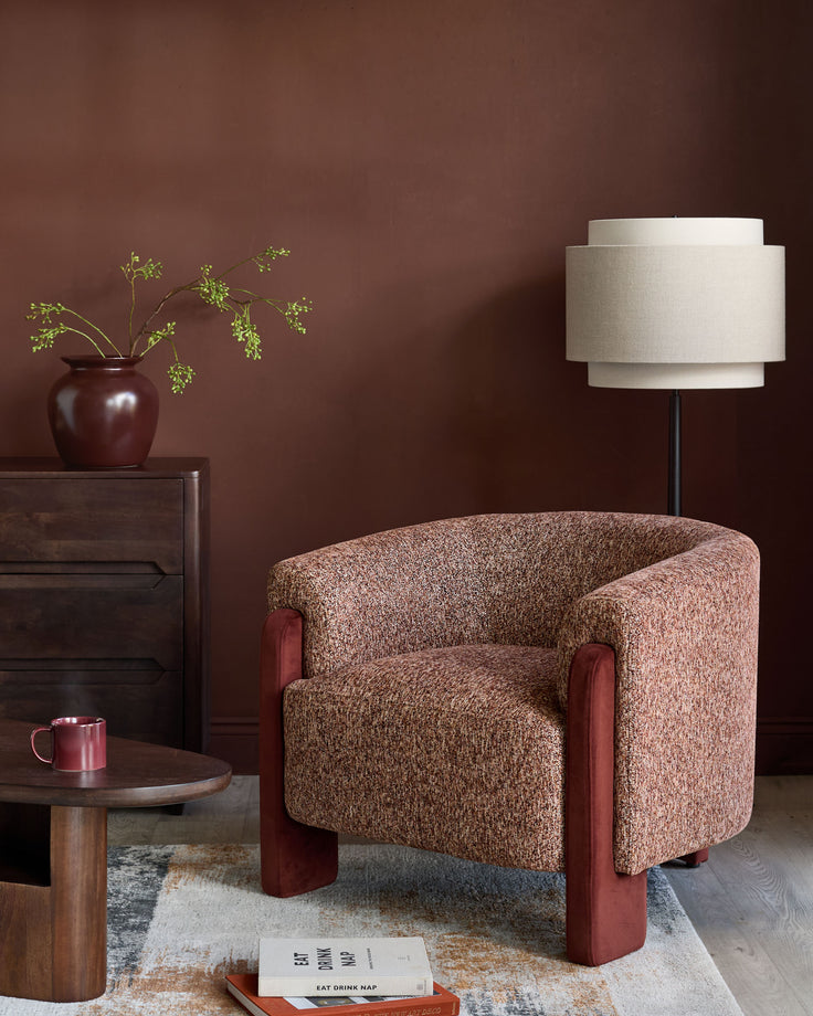 Miles occasional chair in toffee fabric with red velvet armrests, shown in a styled living room setting.