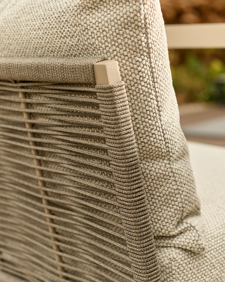 Close-up of natural woven fabric and wooden slat detail on corner bench with square handle accent.
