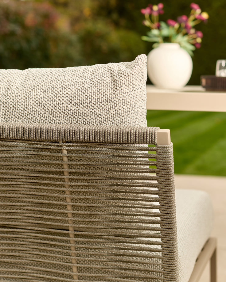Minori garden corner bench in natural color, showing close-up of woven seat texture and slatted backrest detail.