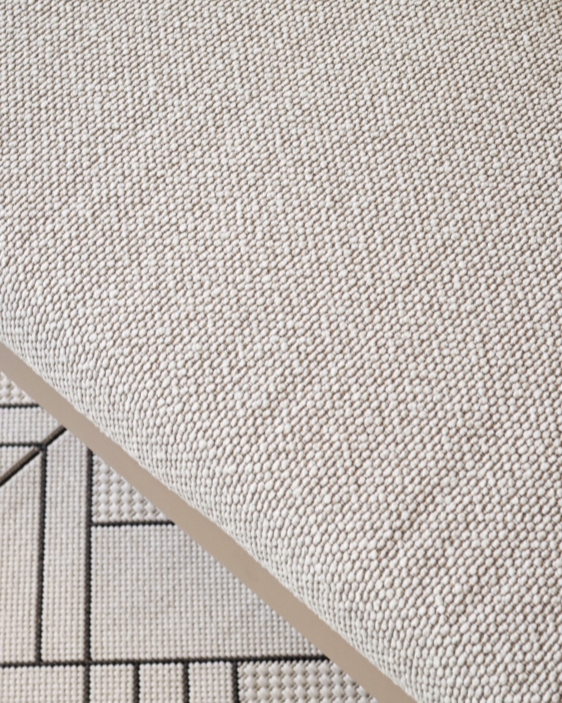 Close-up of natural cream fabric texture on Minori Garden 3-seater dining bench with beige piping detail visible.