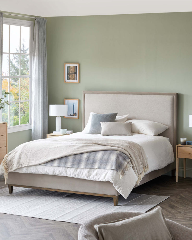 A stylish bedroom with a bed, bedside tables, lamps, and a rug, creating a cosy and inviting space.