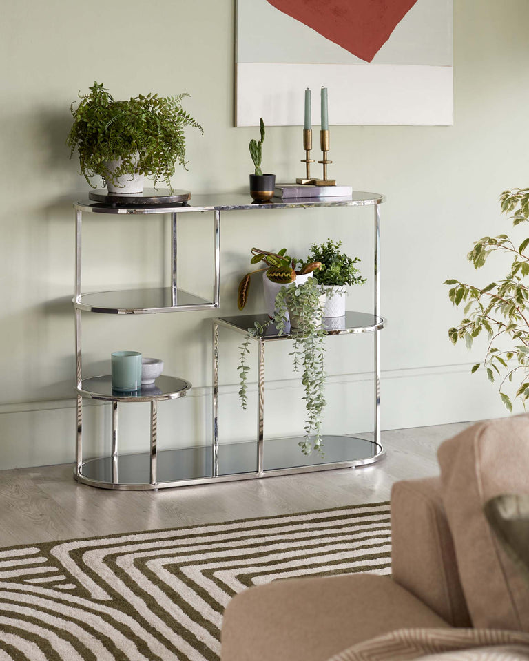 A modern three-tiered shelving unit with a chrome or polished silver finish and circular supports. Each shelf features what appears to be a marble surface with distinctive grey veining, presenting an elegant and contemporary design.