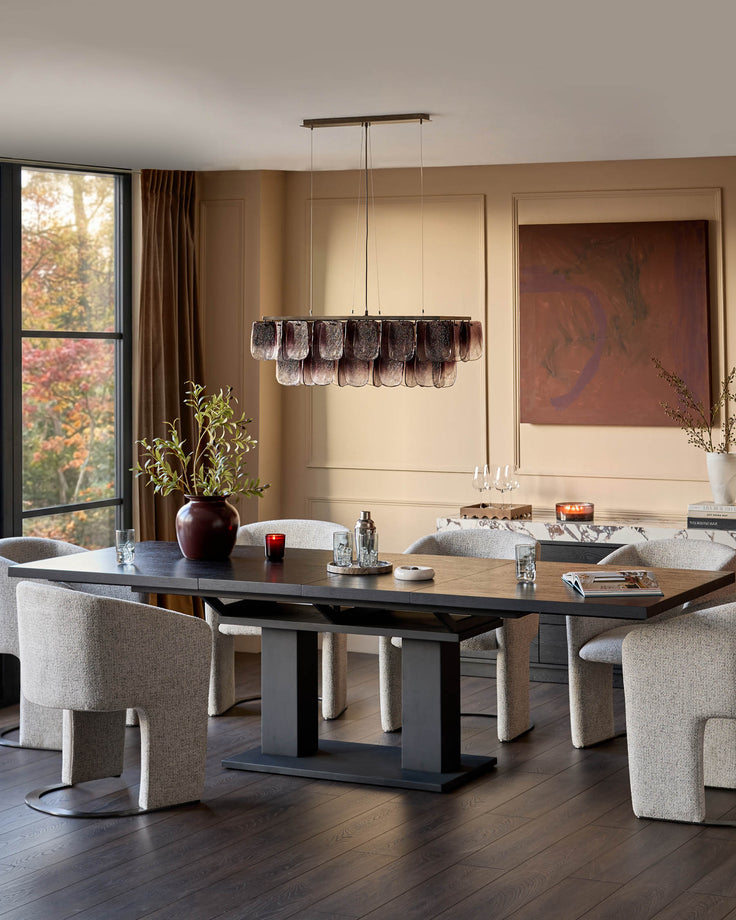 Morgan dining table in dark wood with black base, extending to 10 seats, shown with beige upholstered chairs in modern dining room setting.