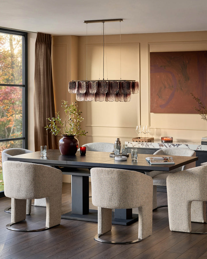 Morgan 8-10 seater dining table in dark wood, rectangular with pedestal base, styled with beige chairs in a modern dining room.
