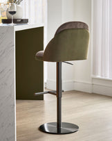 Myra gas lift bar stool in mocha and olive green velvet, shown from rear angle with chrome base and footrest.