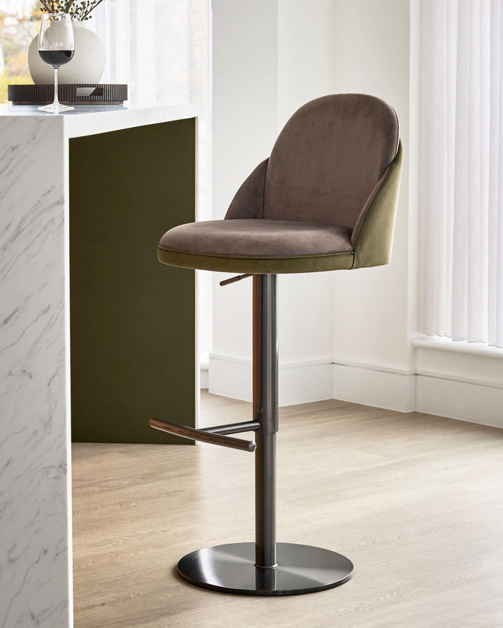 Myra gas lift bar stool in mocha and olive green velvet, shown at an angle with black metal base and footrest.