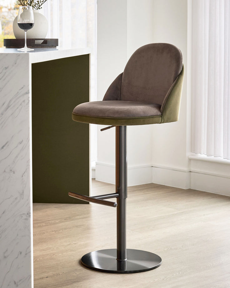 Myra gas lift bar stool in mocha and olive green velvet, shown at an angle with black metal base and footrest.