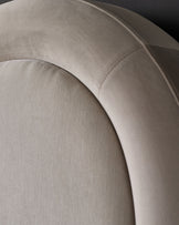 Naomi king-size ottoman bed in champagne velvet, close-up detail of curved headboard and upholstered finish.