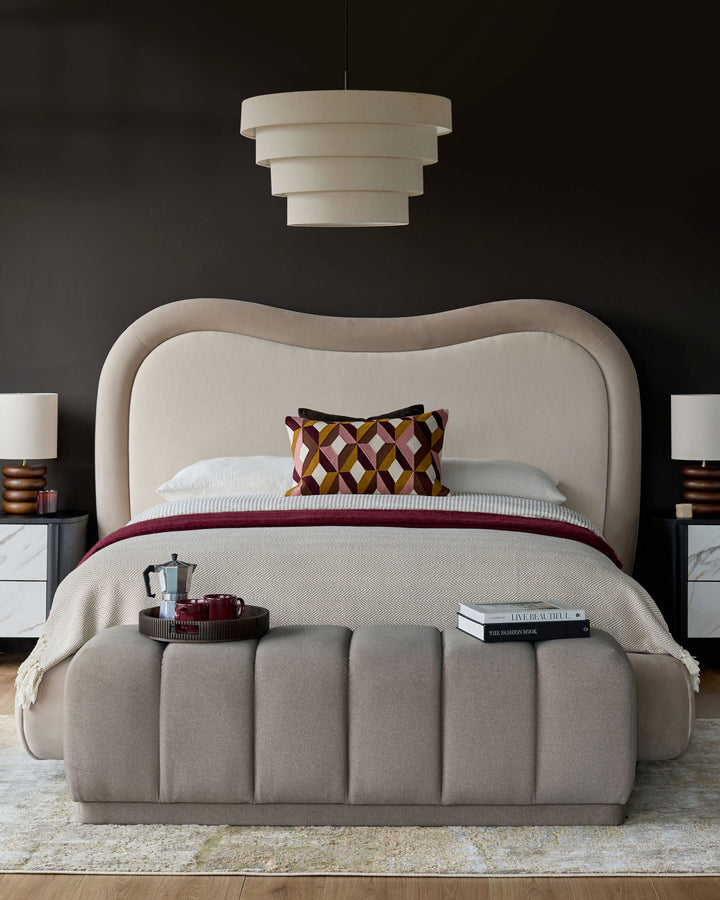 Naomi king-size ottoman bed in champagne velvet with curved headboard, shown in bedroom setting with styling.