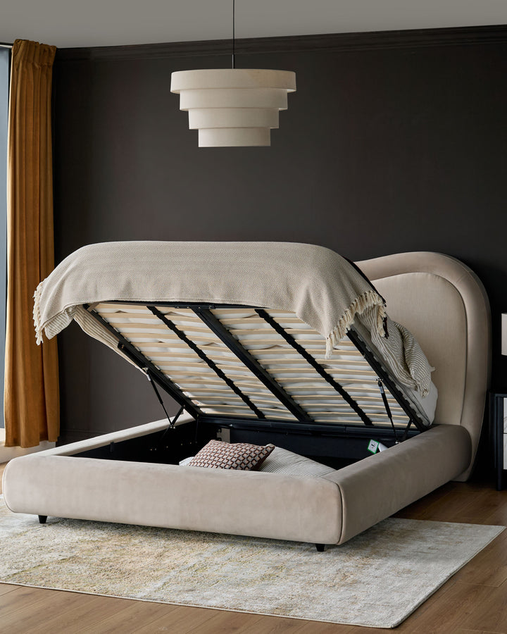 Naomi King-Size Ottoman Bed in champagne velvet with the storage base open, showing wooden slats and storage compartment.
