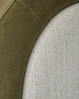 Naomi ottoman bed close-up showing olive green velvet headboard panel alongside natural linen upholstery detail.