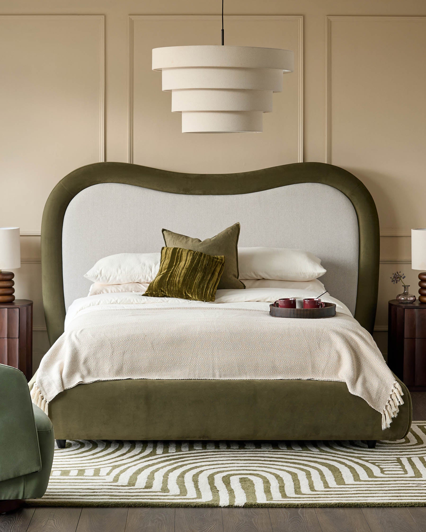Naomi king-size ottoman bed in olive-green velvet with curved headboard and natural linen upholstered backrest.