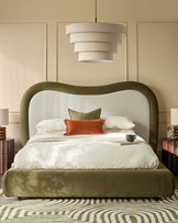 Naomi king-size ottoman bed in olive-green velvet with arched headboard and natural linen backrest, styled in bedroom setting.