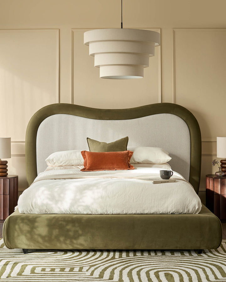 Naomi king-size ottoman bed in olive-green velvet with arched headboard and natural linen backrest, styled in bedroom setting.