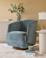 Stylish blue armchair, lamp on side table, and decorative cabinet create a cosy and inviting living space.