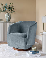 A stylish blue swivel chair sits on a rug, complemented by side tables and a decorative vase.