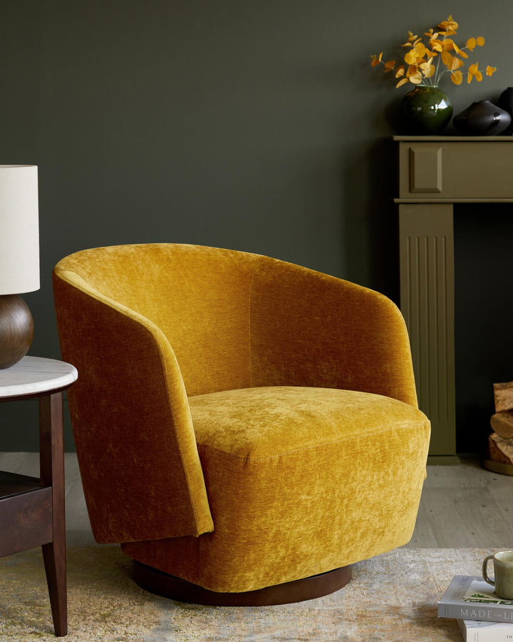 A mustard velvet swivel armchair sits alongside a side table and fireplace. Elegant living room furniture.
