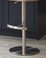 Harper champagne gas lift bar stool with brushed metal base and curved footrest detail.