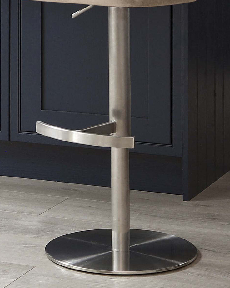 Harper champagne gas lift bar stool with brushed metal base and curved footrest detail.