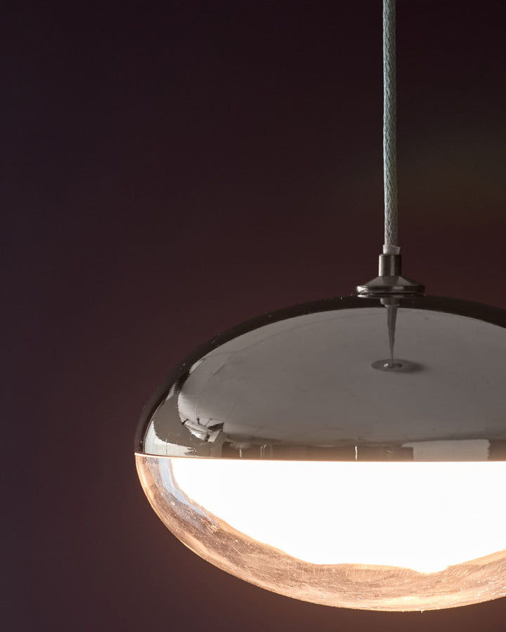 Nina single pendant light with silver chrome finish, featuring a dome-shaped glass shade with natural wood accent detail.