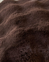 Close-up of Nova Large Cushion in chocolate brown showing soft, plush fabric texture and folds.