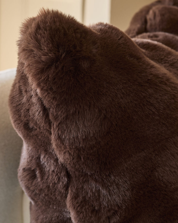 Nova cushion large in chocolate brown, close-up of soft fuzzy texture and rounded shape.