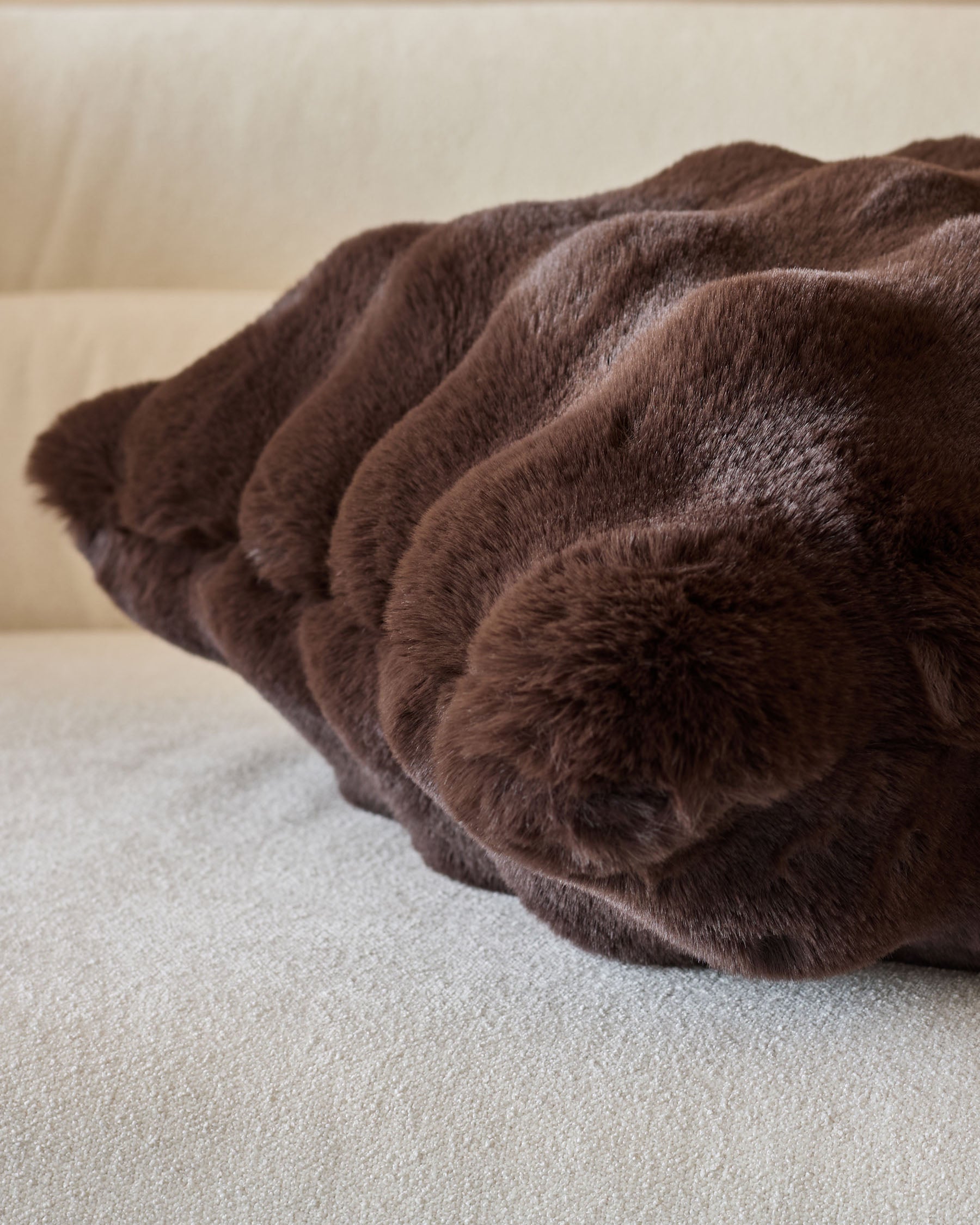 Nova Cushion Large in chocolate brown, showing plush textured fabric with gathered ruching detail and soft, comfortable appearance.