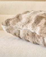 Nova Cushion Large in natural, showing plush texture and gathered wavy detail, displayed on neutral surface.