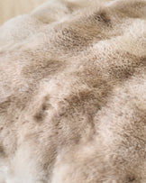 Close-up of Nova Cushion Large in natural beige, showing soft plush texture and subtle color variations.