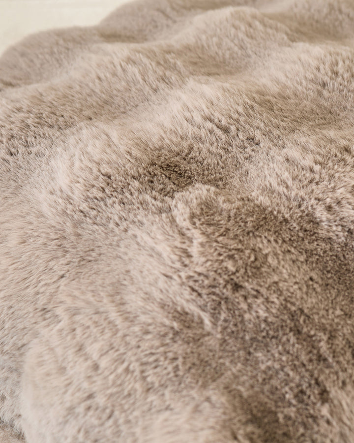Close-up of taupe Nova large cushion showing soft, textured fabric surface with subtle color variations.