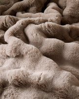 Nova Throw Large in taupe, close-up showing soft, plush fabric texture and relaxed folds.
