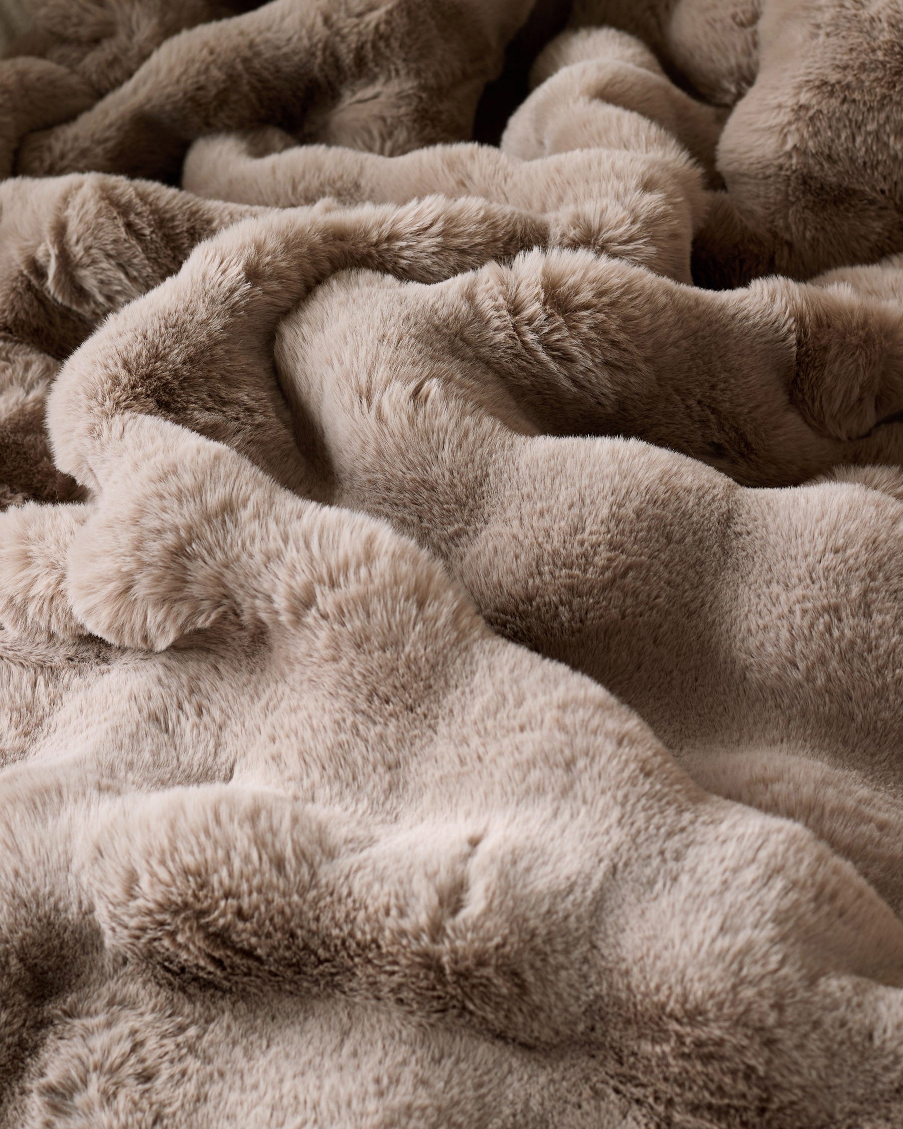 Nova Throw Large in taupe, close-up showing soft, plush fabric texture and relaxed folds.