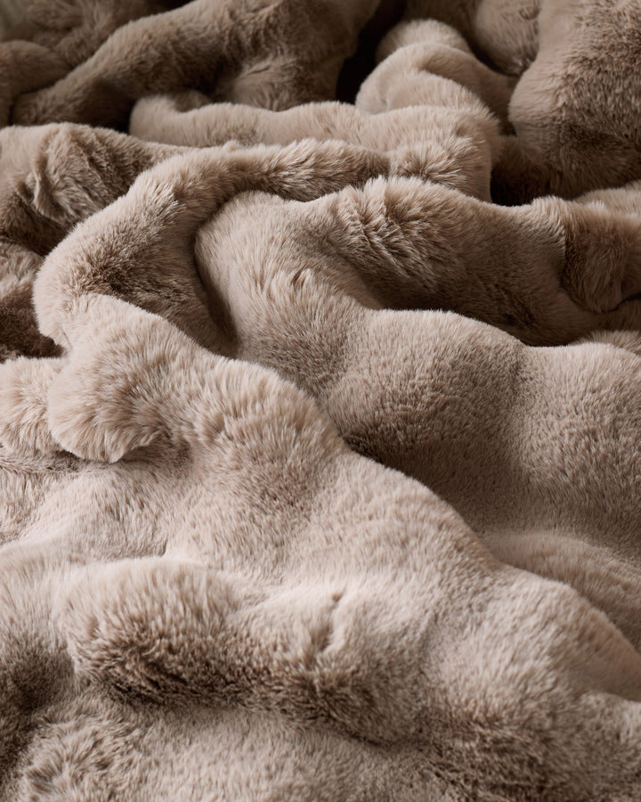 Nova Throw Large in taupe, close-up showing soft, plush fabric texture and relaxed folds.