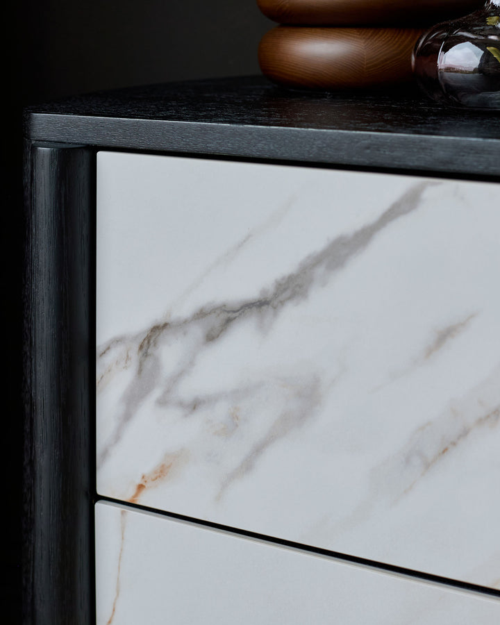 Orlan bedside table with black wooden frame and marble ceramic top featuring natural veining.