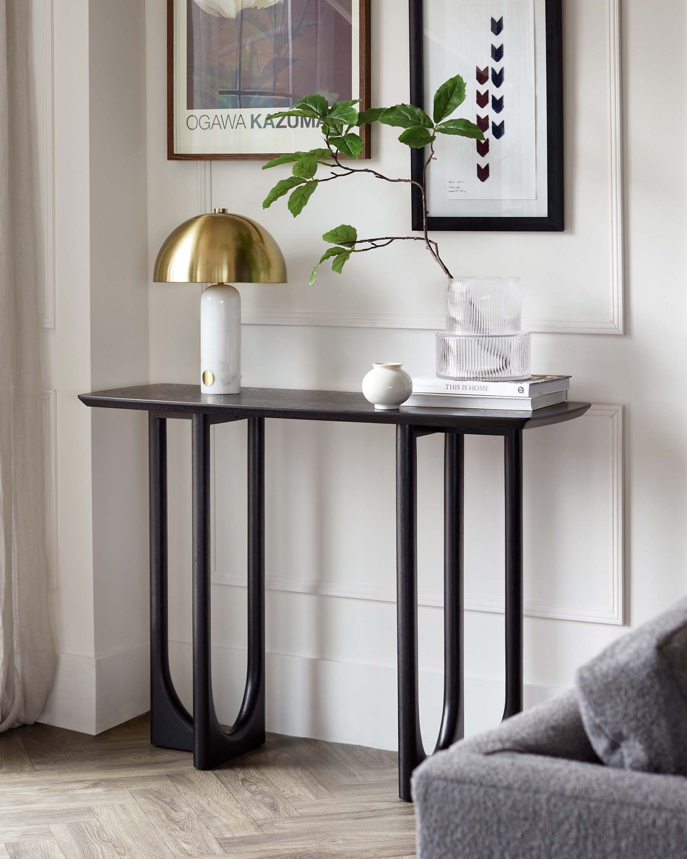 Elegant dark wood console table with a slim rectangular top and unique curved leg design, creating a contemporary and sophisticated appearance.