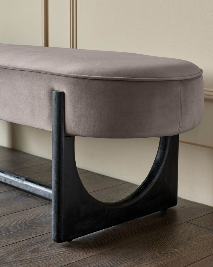 Elegant upholstered bench with black wooden legs, adding a touch of modern luxury to any space.