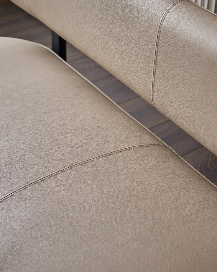 Cream faux leather bench with backrest, showing detailed stitching and dark metal trim accent.