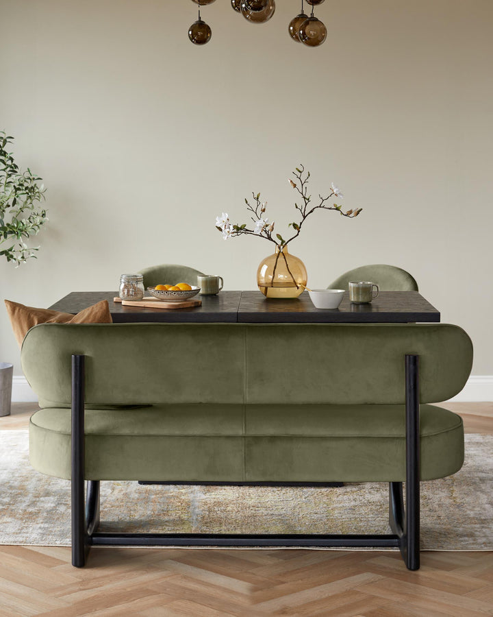 Orlan dining bench with backrest in velvet olive green, featuring curved silhouette and black metal legs, styled with table setting.