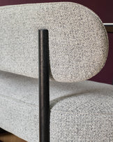 A stylish settee with a textured grey and white fabric, and a dark wood frame. Modern and comfortable.