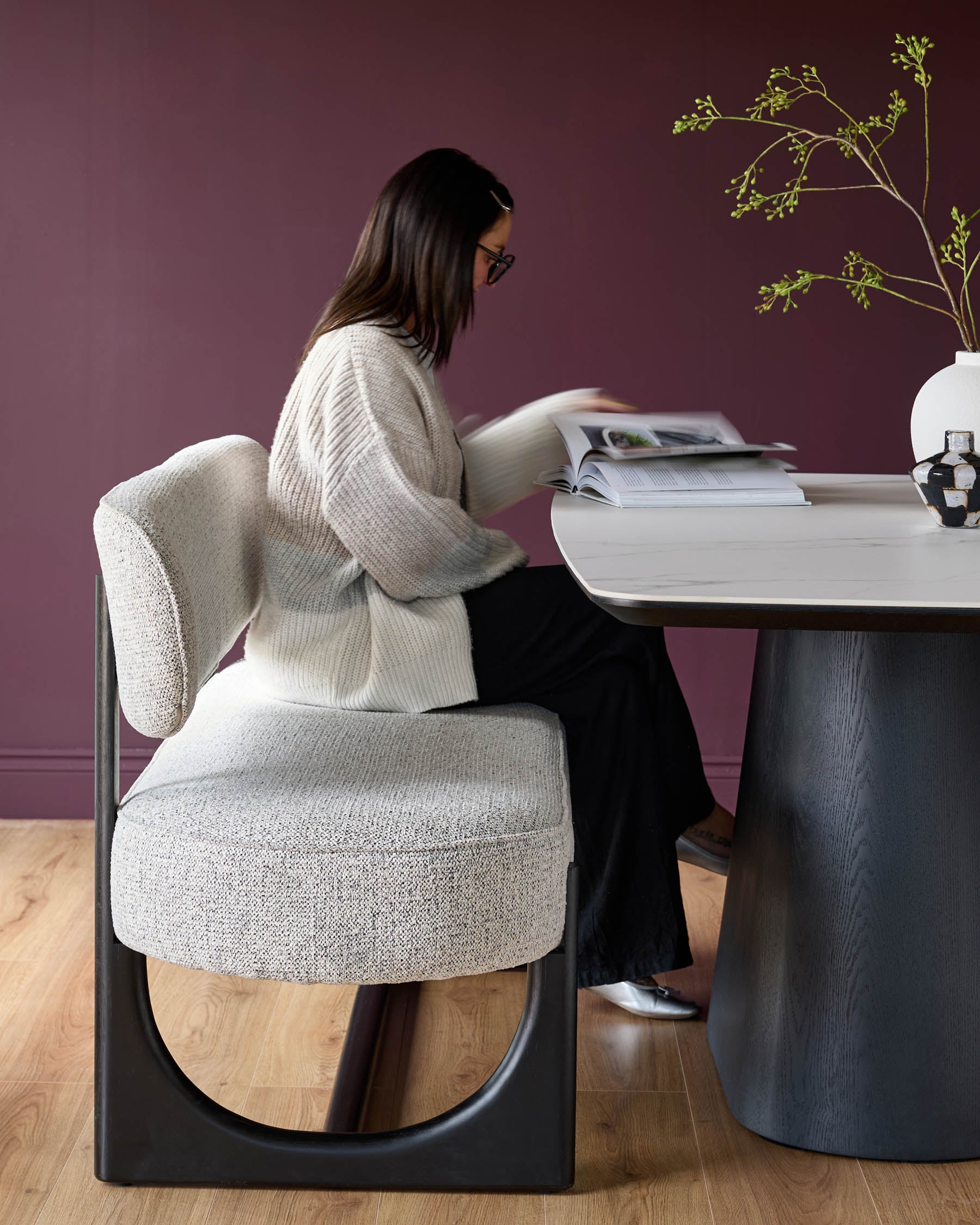 Contemporary dining set featuring a marble-effect table and stylish grey upholstered bench with black frame, offering a modern look.