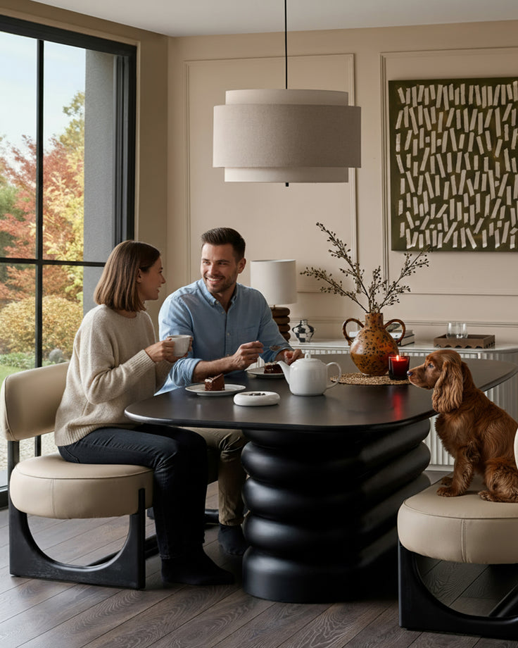 Orlan 3-seating dining bench with backrest in natural faux leather, black sculptural base, styled in modern dining room.