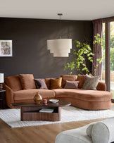 Ottilie right-hand corner chaise sofa in apricot fabric, styled in a modern living room with dark walls and decorative pillows.