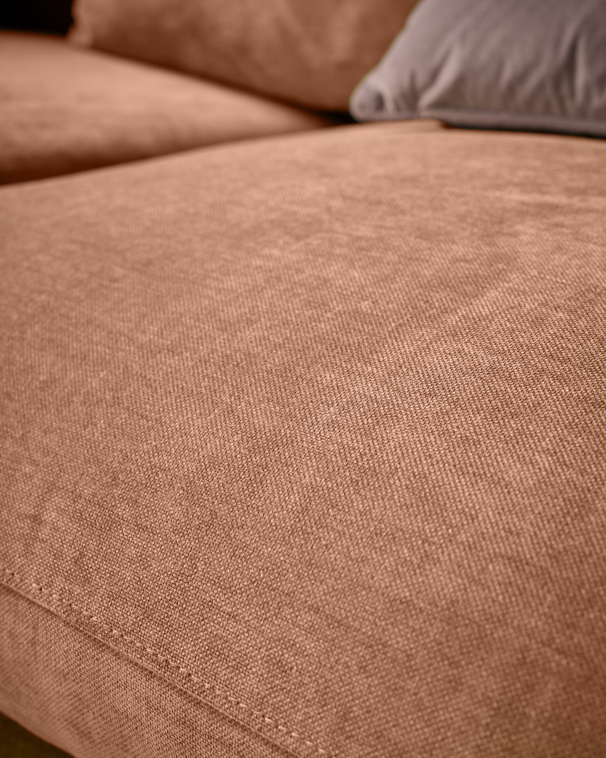 Ottilie right-hand corner chaise sofa in apricot fabric, close-up detail of upholstery texture and seating area.
