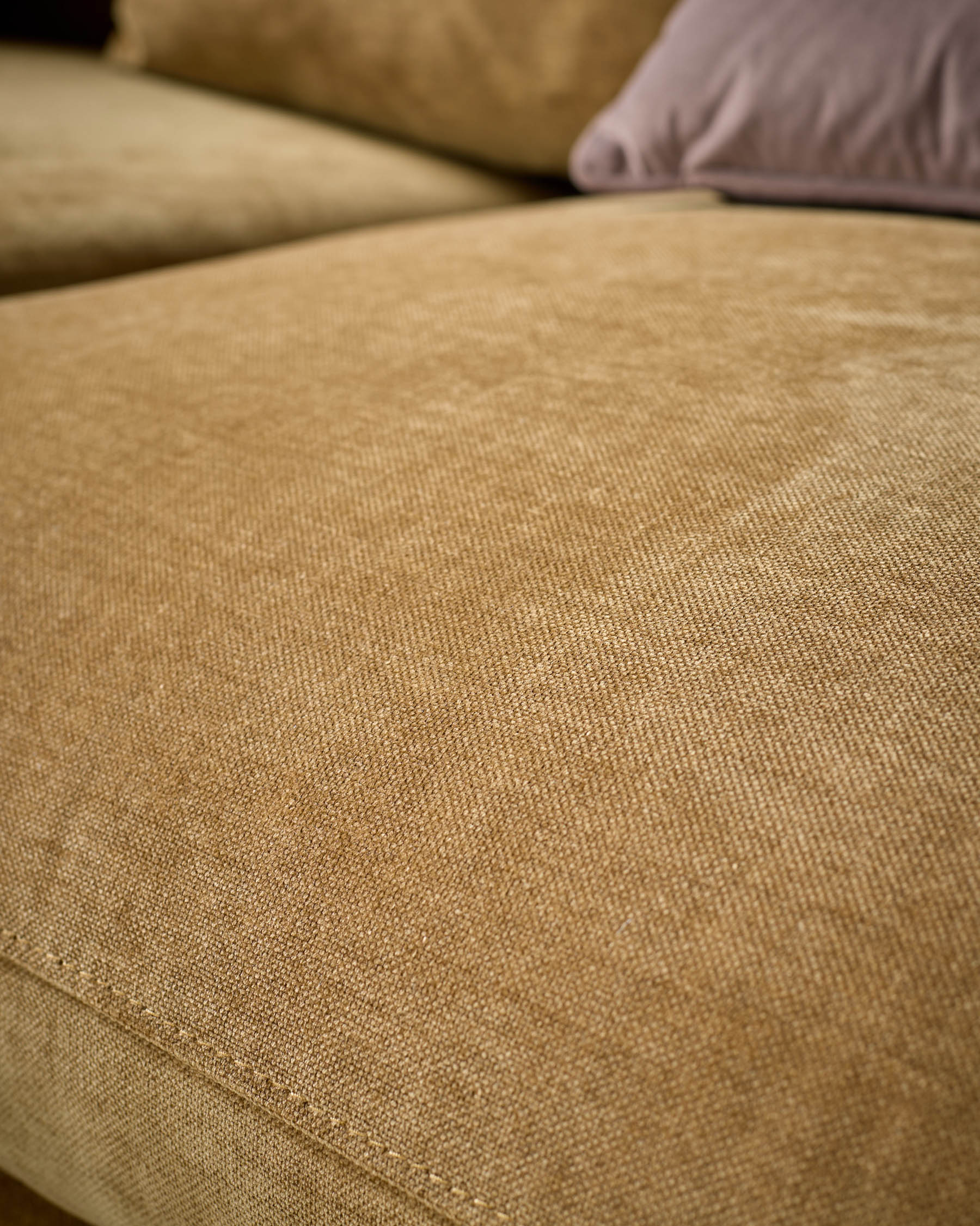 Close-up of ochre fabric on Ottilie right-hand corner chaise sofa, showing texture and weave detail with cushions.