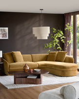 Ochre right-hand corner chaise sofa in a modern living room with dark walls and wooden coffee table.