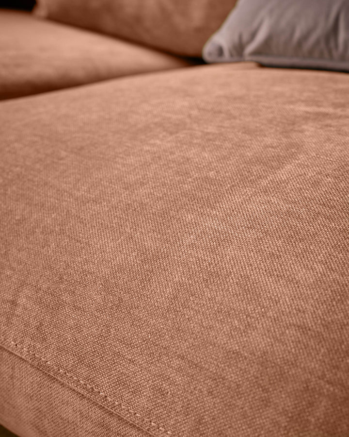 Close-up of apricot fabric on Ottilie left-hand corner chaise sofa, showing soft texture and weave detail with pillows.