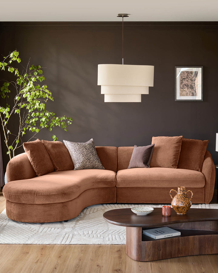 Ottilie left-hand corner chaise sofa in apricot fabric, styled in a modern living room setting with decorative pillows.