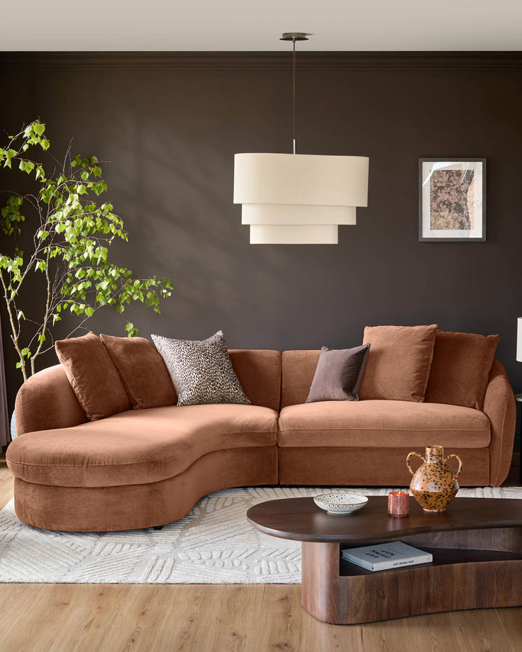 Ottilie left-hand corner chaise sofa in apricot fabric, styled in a modern living room setting with decorative pillows.