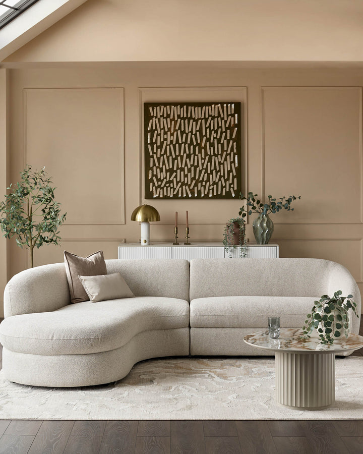 Ottilie left-hand corner chaise sofa in natural fabric, curved design, displayed in neutral living room setting.